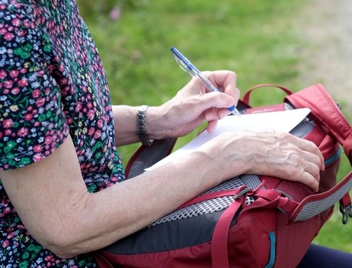 Judith Morris in nature writing her memoir, Stepping out of Silence